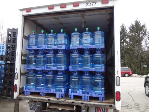 upright water bottle storage rack truck transportation example
