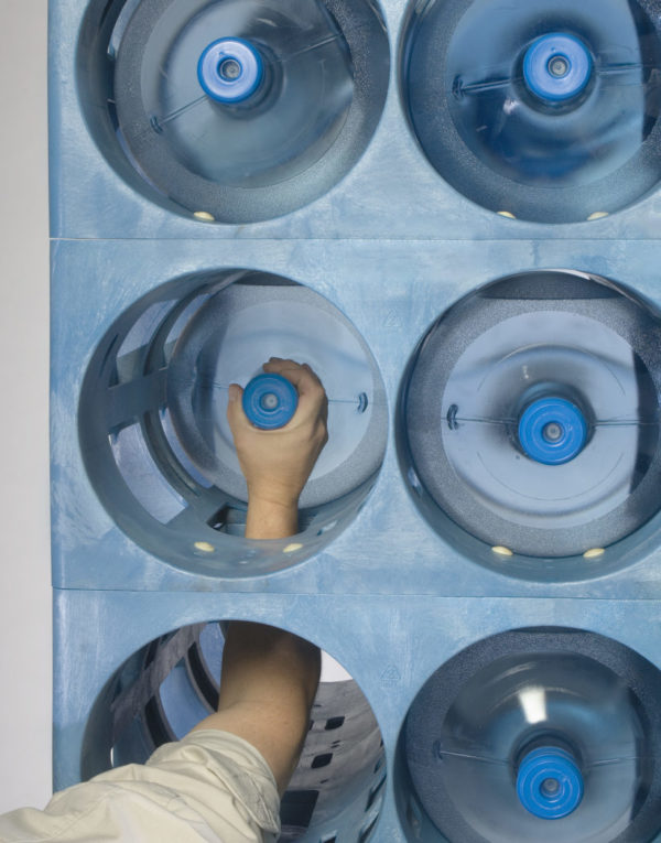 Reach through feature of water bottle plastic storage rack